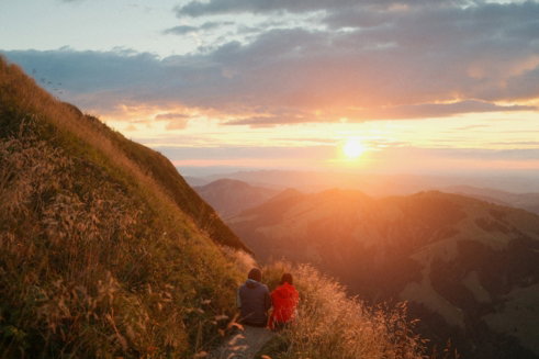 two-people-sitting-on-a-grassy-mountain-path-in-schwende-r-te--switzerland--at-golden-hour.jpg Two people sitting on a grassy mountain path in Schwende-Rüte, Switzerland, at golden hour